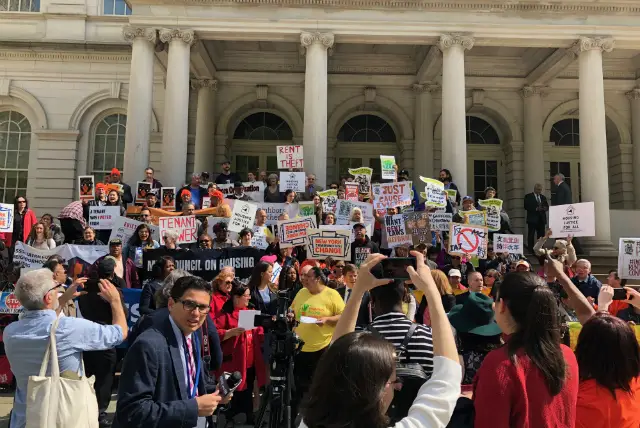 Tenants and state representatives gather outside City Hall before they testified at a state hearing on rent reform laws in Lower Manhattan on Thursday.